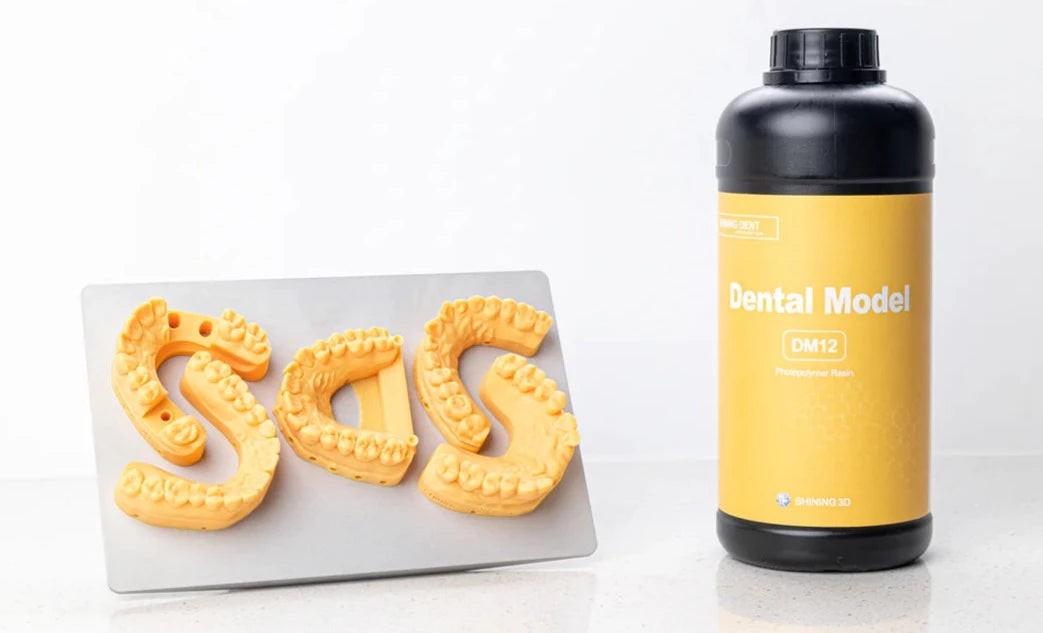 SHINING DENT DM12 resin bottle and yellow dental models printed with it